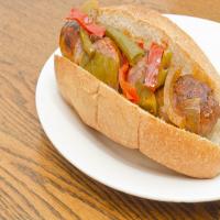 Grilled Sausages, Peppers, and Onions on Rolls image