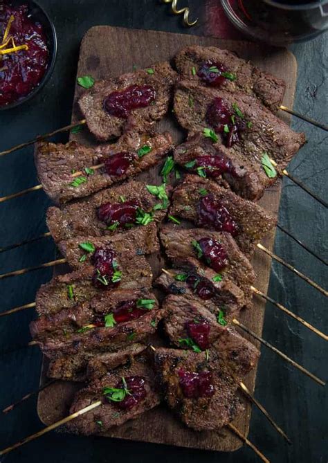 wine-marinated-beef-skewers-with-cranberry-sauce image