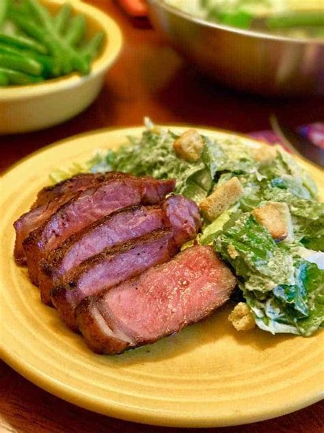 grilled-new-york-strip-steaks-with-caesar-salad image