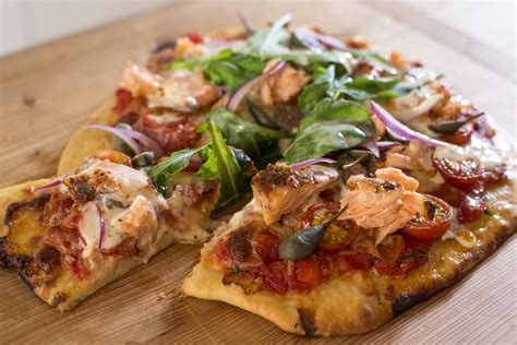 smoked-salmon-pizza-with-tomato-rocket-capers-and image
