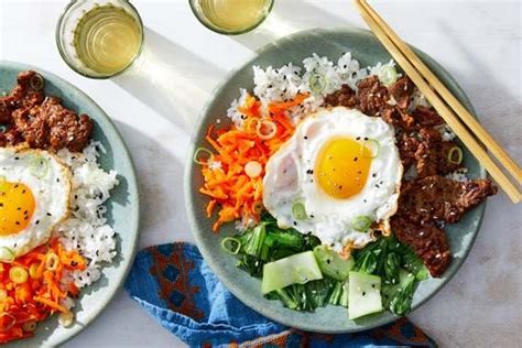 korean-beef-rice-bowls-with-vegetables-fried-eggs image