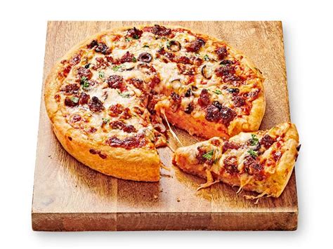 deep-dish-pizza-with-spicy-sausage-and-olives-food-network image