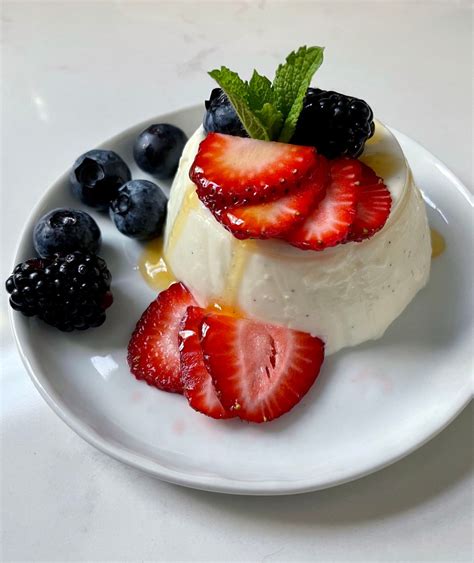 buttermilk-vanilla-panna-cotta-with-berries-and-honey image