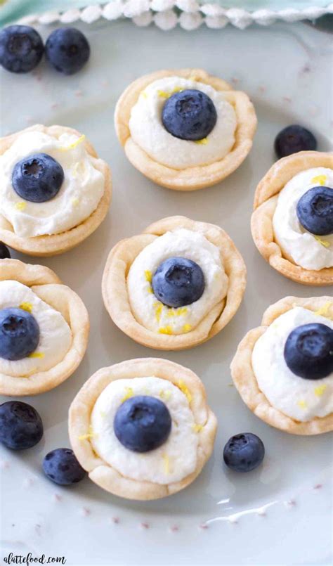 mini-lemon-blueberry-cream-tarts-a-latte-food image